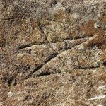 Rovásírásos kő a templomkertben